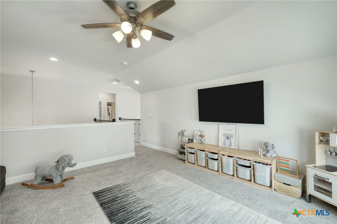 1401 Mulberry Oak Lane Georgetown, TX 78628 - Photo 21 of 30 Living area featuring ceiling fan, vaulted ceiling, carpet, baseboards, and recessed lighting