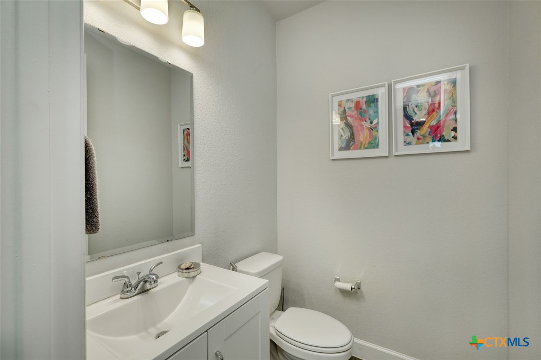 1401 Mulberry Oak Lane Georgetown, TX 78628 - Photo 25 of 30 Half bathroom with toilet and vanity