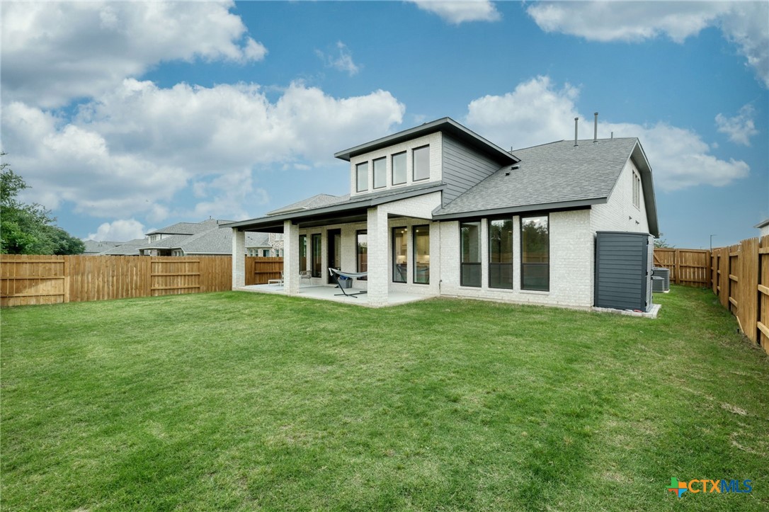 1401 Mulberry Oak Lane Georgetown, TX 78628 - Photo 27 of 30 Back of house with brick siding, a shingled roof, and a patio area