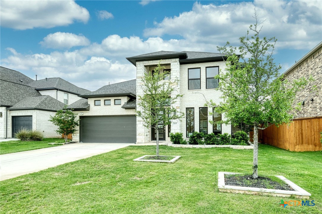 1401 Mulberry Oak Lane Georgetown, TX 78628 - Photo 3 of 30 View of front of property featuring driveway, stone siding, brick siding, and a shingled roof