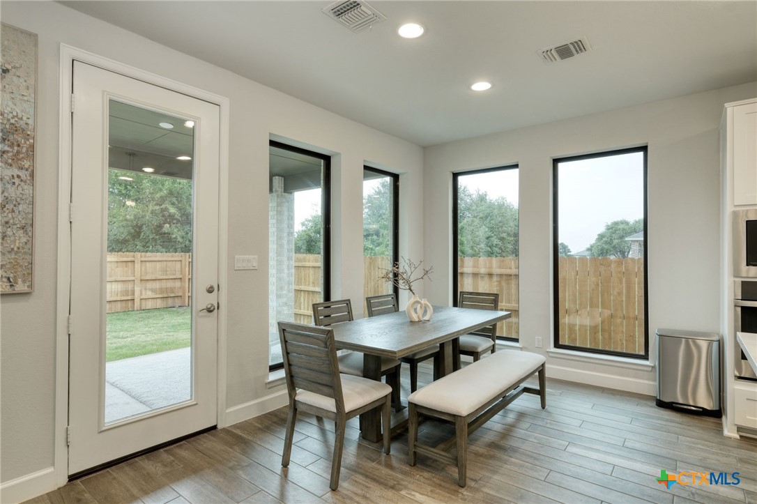 1401 Mulberry Oak Lane Georgetown, TX 78628 - Photo 10 of 29 a dining room with furniture and wooden floor