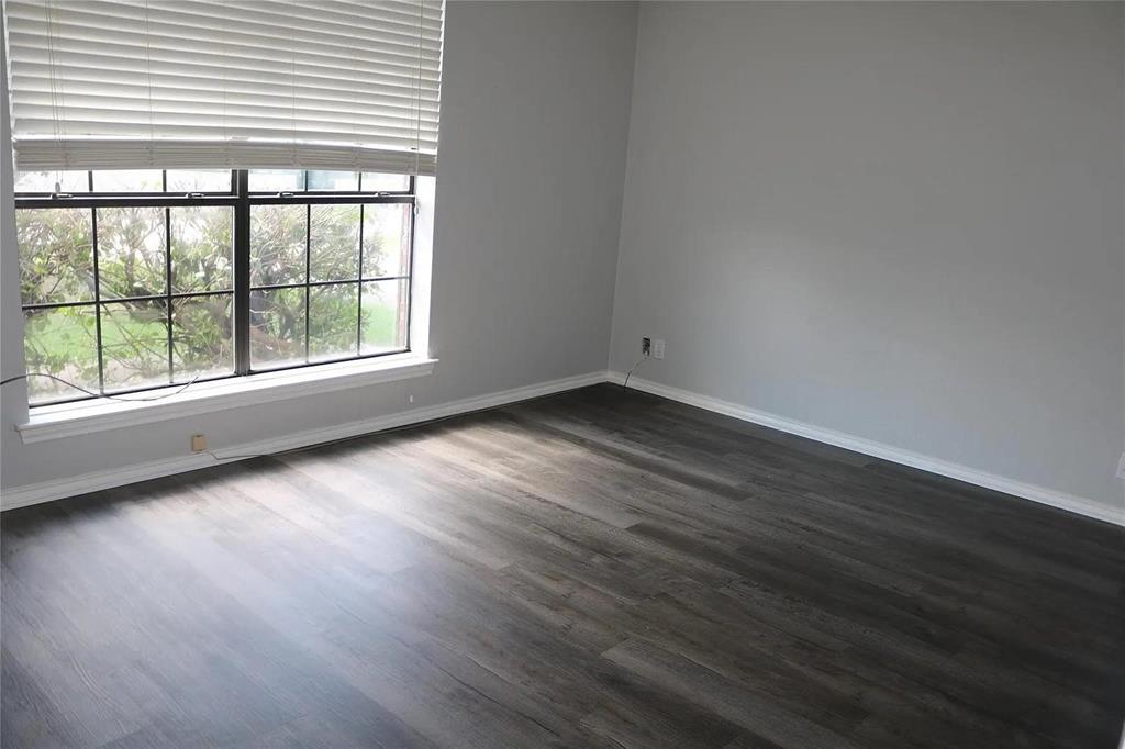 627 Cherry Lane Southlake, TX 76092 - Photo 11 of 19 Empty room featuring dark wood-style floors and baseboards