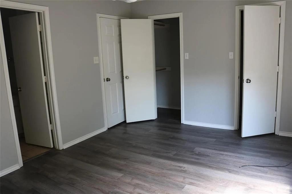 627 Cherry Lane Southlake, TX 76092 - Photo 12 of 19 Unfurnished bedroom with dark wood-style flooring and baseboards