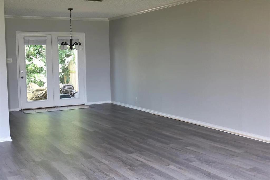 627 Cherry Lane Southlake, TX 76092 - Photo 5 of 19 Unfurnished dining area with crown molding, dark wood-style floors, a chandelier, and a textured ceiling