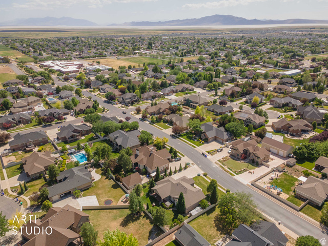 2327 Bluff Ridge Drive Syracuse, UT 84075 - Photo 66 of 66 Expansive residential neighborhood featuring a variety of single-family homes with pitched roofs, mature landscaping, and an outdoor swimming pool in a private backyard setting