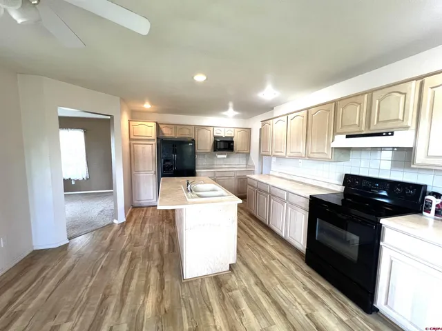 a kitchen with stove and cabinets