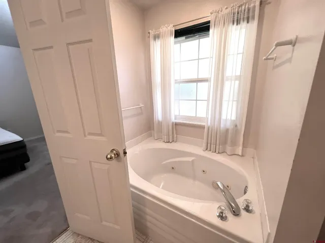 a white bath tub sitting next to a window