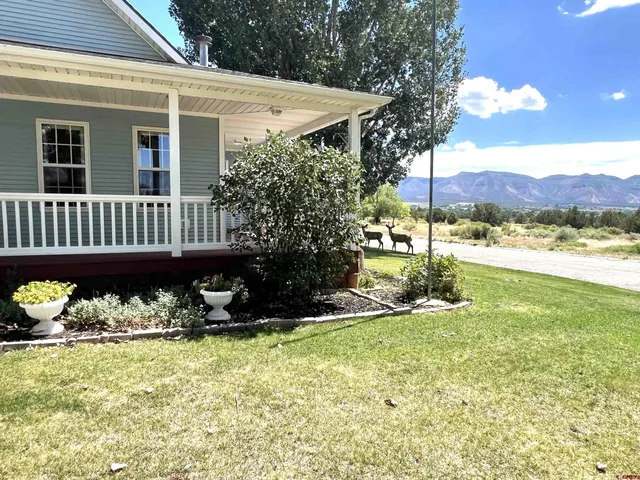 a view of a chair and tables in the patio