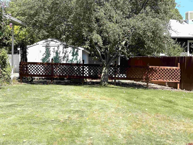 a view of a wooden door and a yard