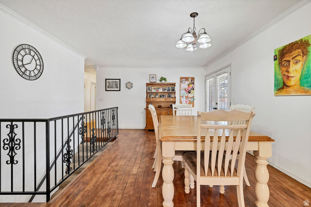 3334 Ute Road St. George, UT 84790 - Photo 7 of 40 Dining space featuring ornamental molding, hardwood / wood-style floors, and suspended lighting