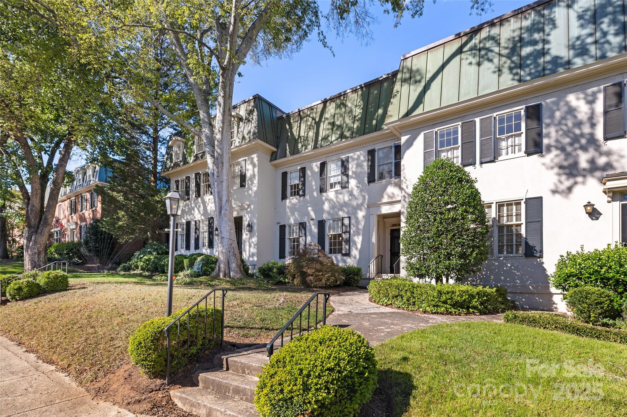 front view of a building with a garden