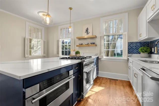 a kitchen with stainless steel appliances granite countertop a stove and a sink