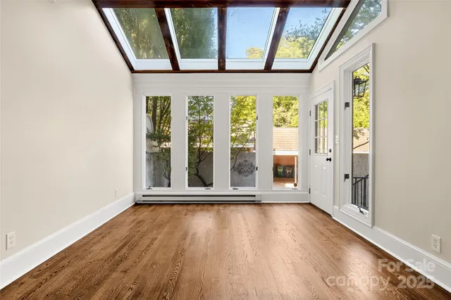 a view of an entryway with wooden floor