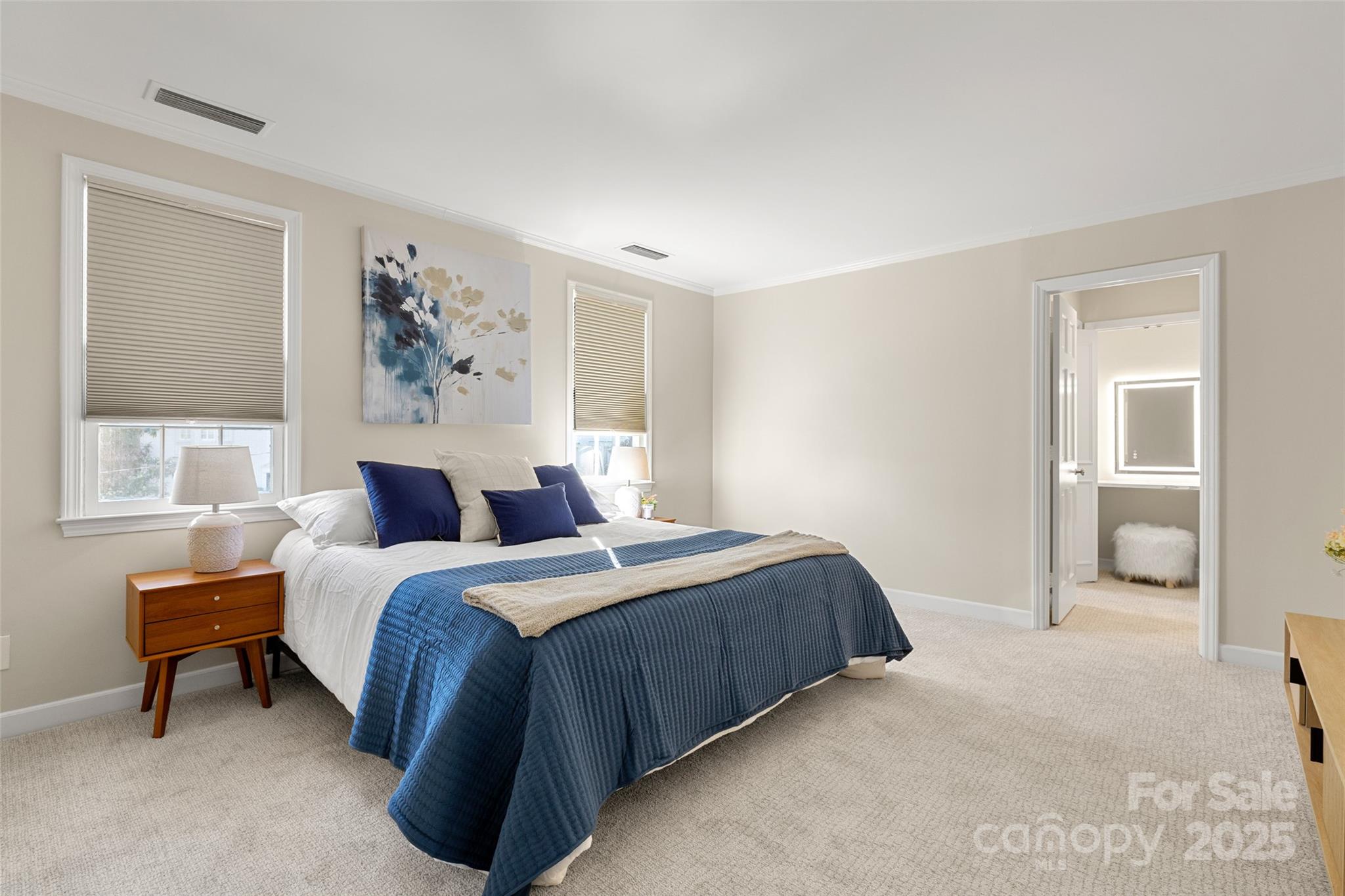 153 Perrin Place, Unit 153 Charlotte, NC 28207 - Photo 19 of 28 a bedroom with a bed and a painting on the wall