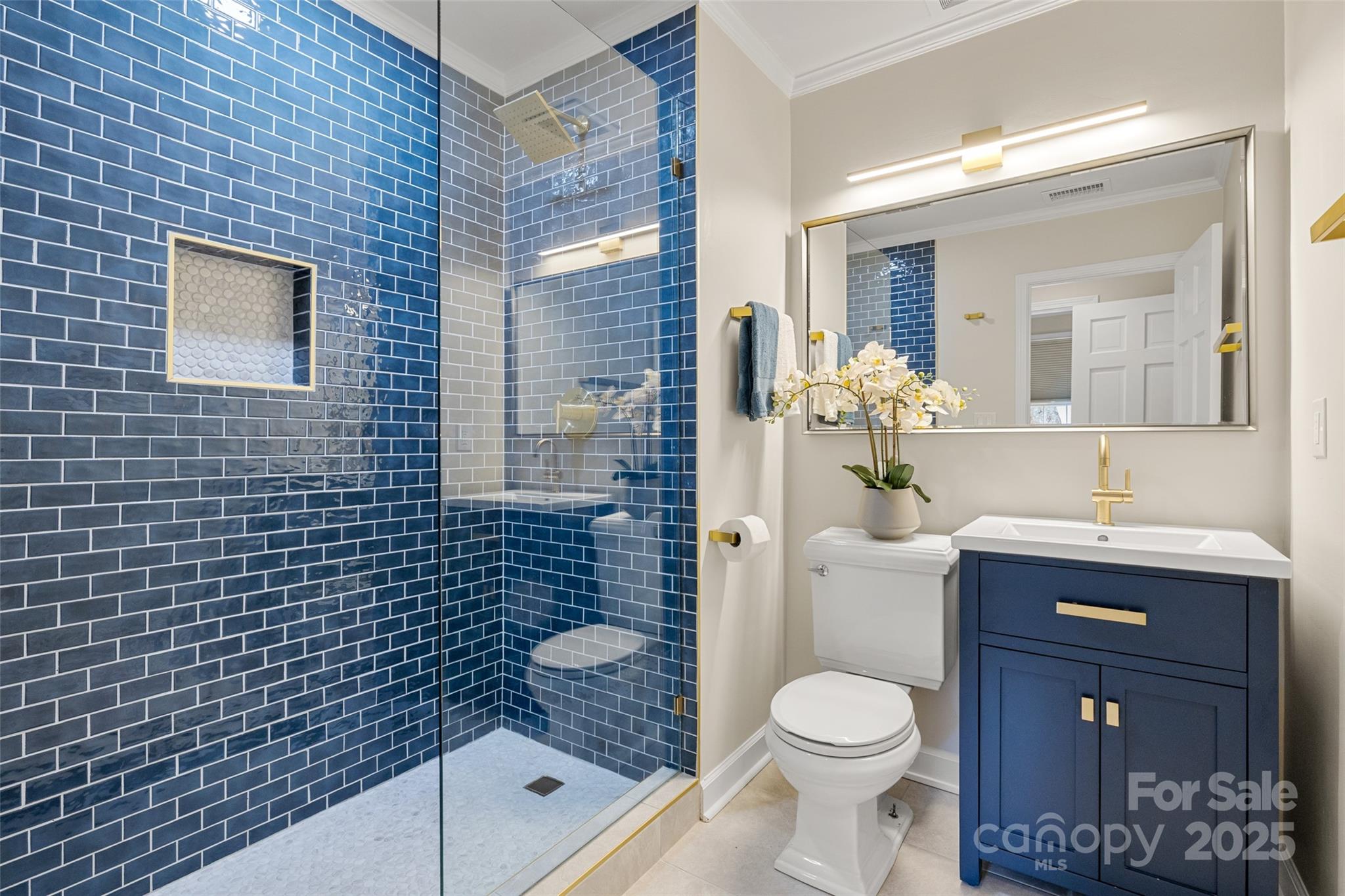 153 Perrin Place, Unit 153 Charlotte, NC 28207 - Photo 22 of 28 a bathroom with a granite countertop toilet a sink a mirror and shower
