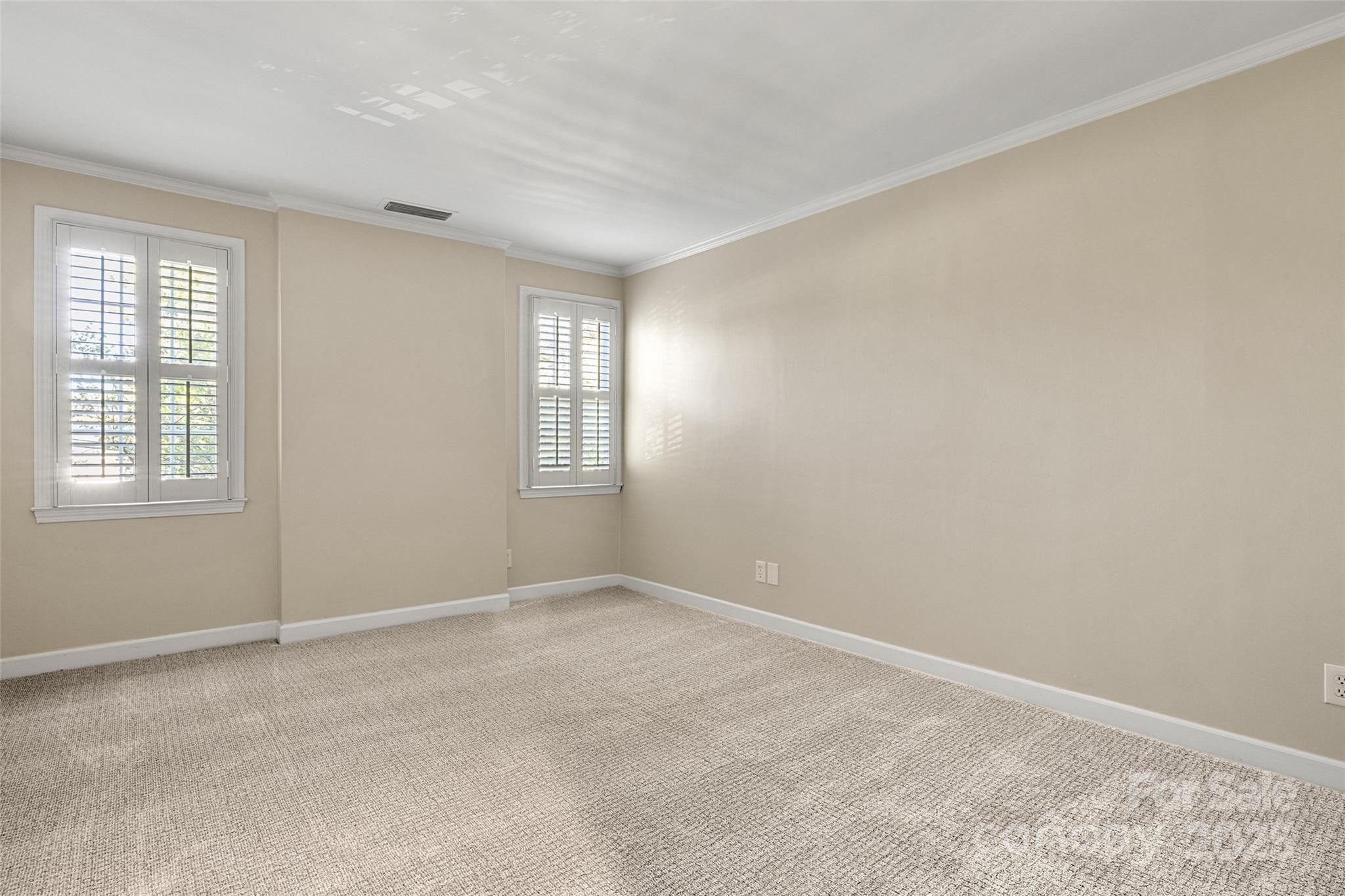 153 Perrin Place, Unit 153 Charlotte, NC 28207 - Photo 23 of 28 a view of an empty room with a window