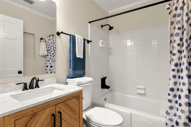 a bathroom with a sink toilet a mirror and shower