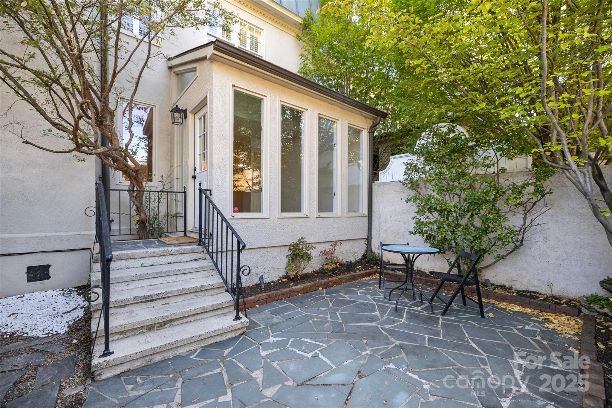 153 Perrin Place, Unit 153 Charlotte, NC 28207 - Photo 28 of 28 a view of a house with a large window and wooden fence