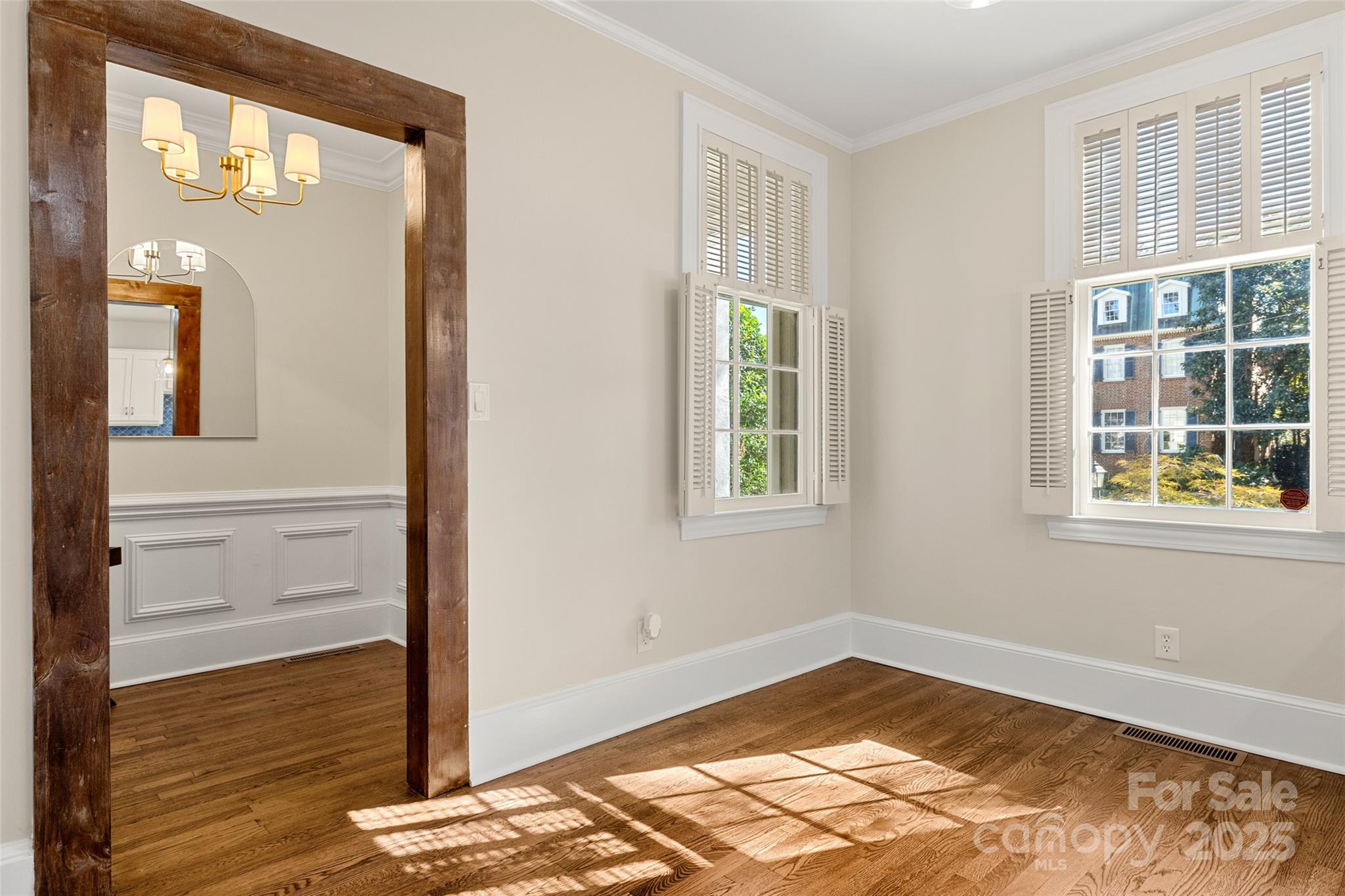 153 Perrin Place, Unit 153 Charlotte, NC 28207 - Photo 8 of 28 a view of empty room with wooden floor and fan