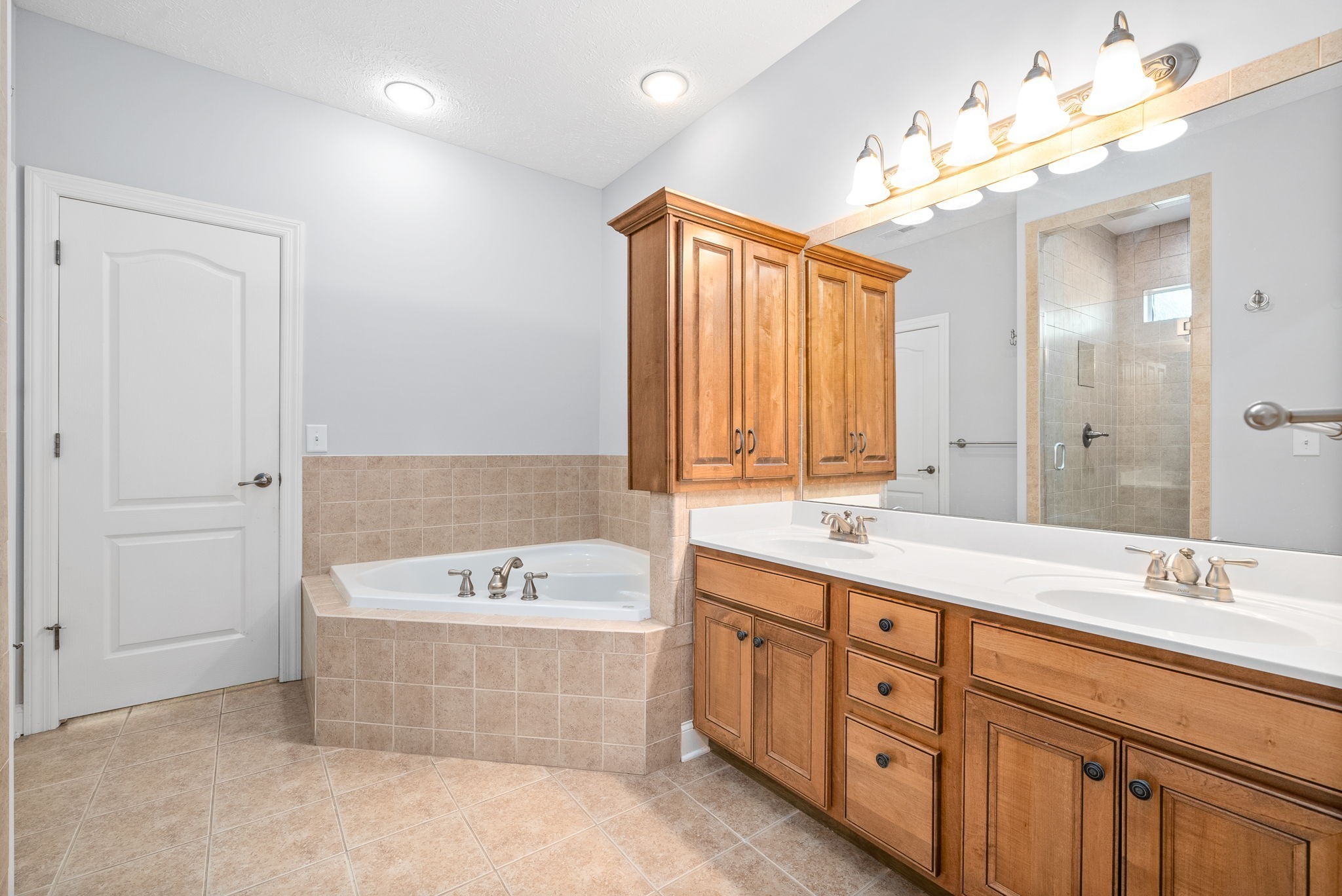 245 Cullom Way Clarksville, TN 37043 - Photo 29 of 74 a bathroom with a tub a double vanity sink and a mirror