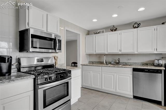 513 Huron Road Colorado Springs, CO 80910 - Photo 13 of 26 Kitchen with stainless steel appliances with gas range.