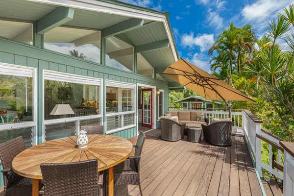 a view of a patio with table and chairs and wooden floor
