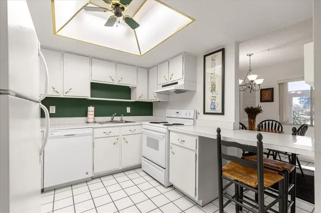 a kitchen with a sink cabinets and window