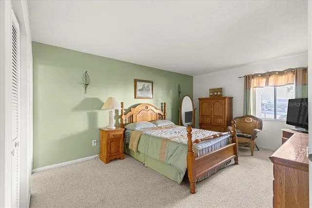 a bedroom with bed and a window