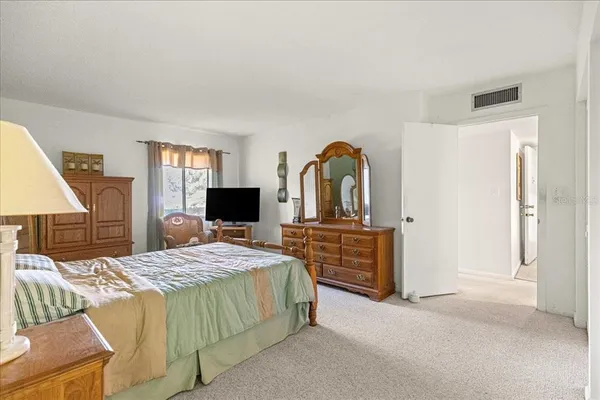 a bedroom with a bed and a dresser