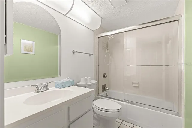 a bathroom with a sink mirror toilet and shower