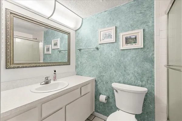 a white toilet sitting next to a bathroom sink