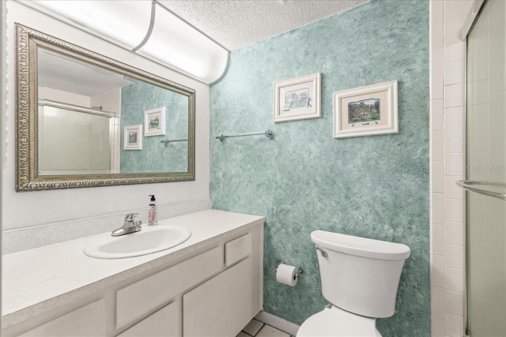 584 Fairways Circle, Unit A Ocala, FL 34472 - Photo 19 of 41 a bathroom with a toilet a sink and mirror