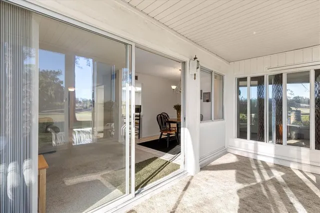 a view of a hallway with a glass door and glass door