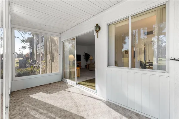 a view of a building with sitting area and garden