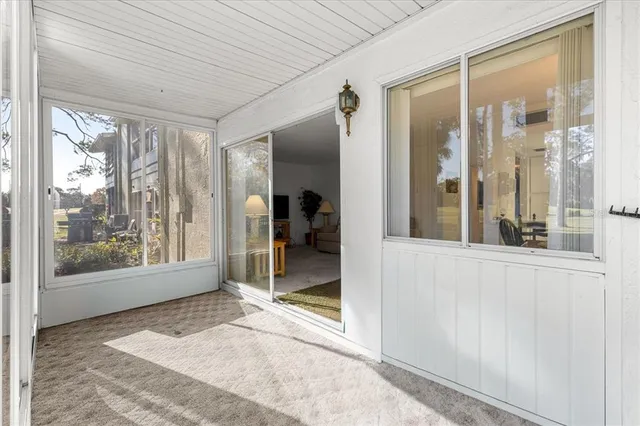 a view of a building with sitting area and garden