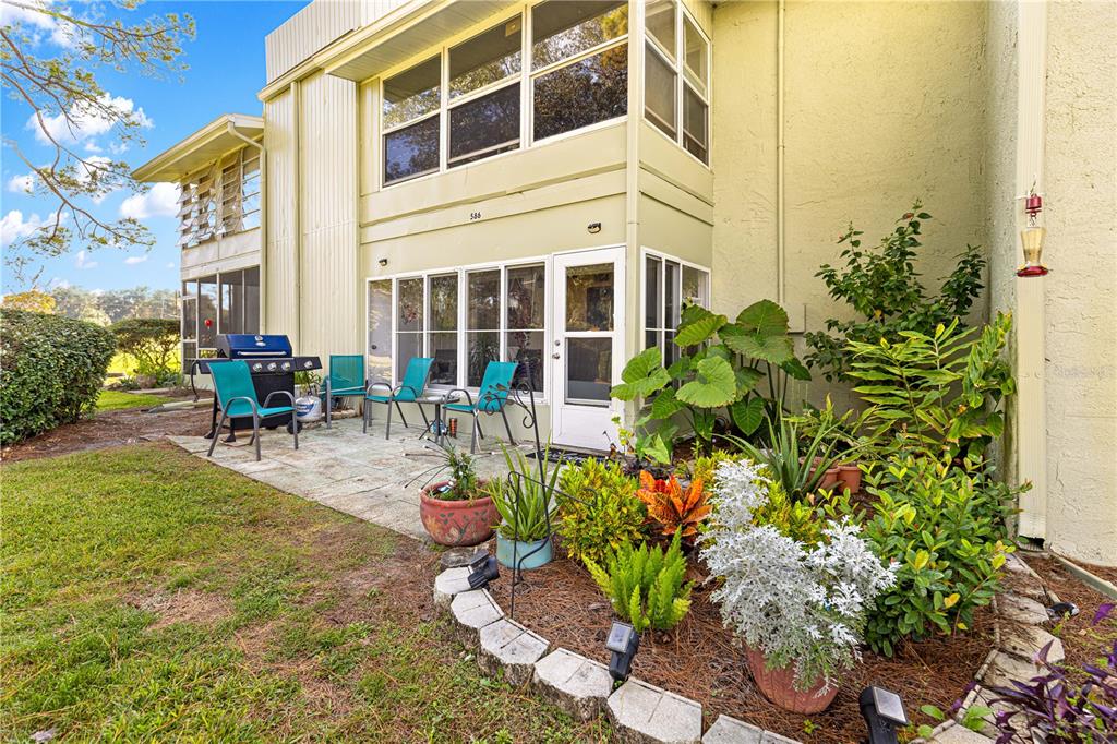 584 Fairways Circle, Unit A Ocala, FL 34472 - Photo 24 of 41 a view of a building with sitting area and garden