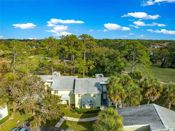 an aerial view of residential houses with outdoor space and street view