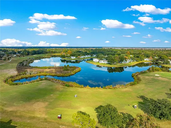 a view of a lake with houses in the back