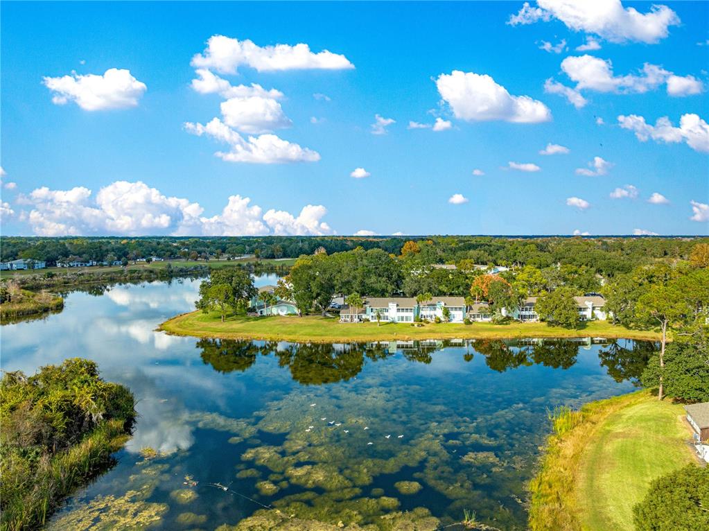 584 Fairways Circle, Unit A Ocala, FL 34472 - Photo 39 of 41 a view of a lake with houses in the back