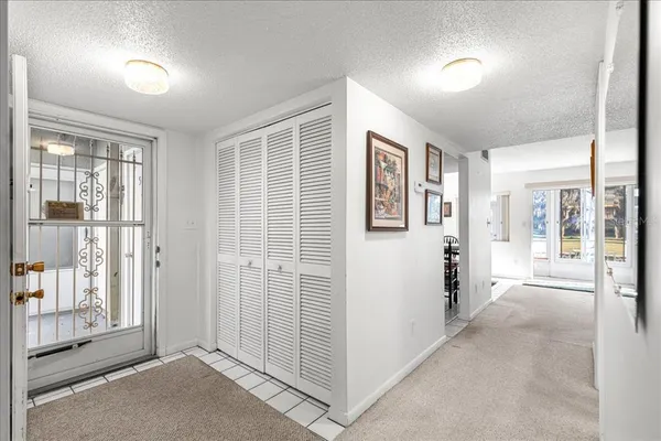 a view of a big room with windows and entryway of the house