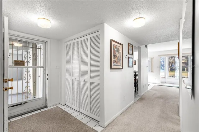 a view of a big room with windows and entryway of the house