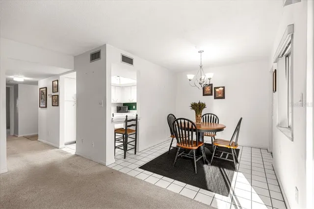 a view of a dining room with furniture and window