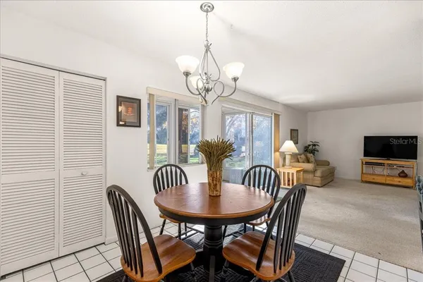 a view of a dining room with furniture and a chandelier
