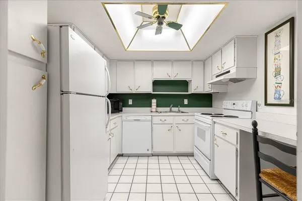 a kitchen with stainless steel appliances a refrigerator sink and cabinets