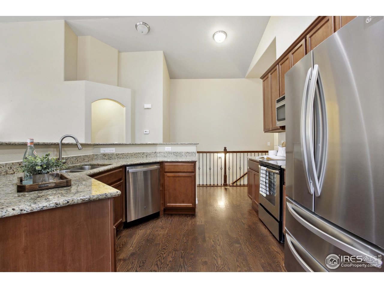 9018 Sandpiper Drive Frederick, CO 80504 - Photo 11 of 26 a kitchen with granite countertop a sink stainless steel appliances and cabinets