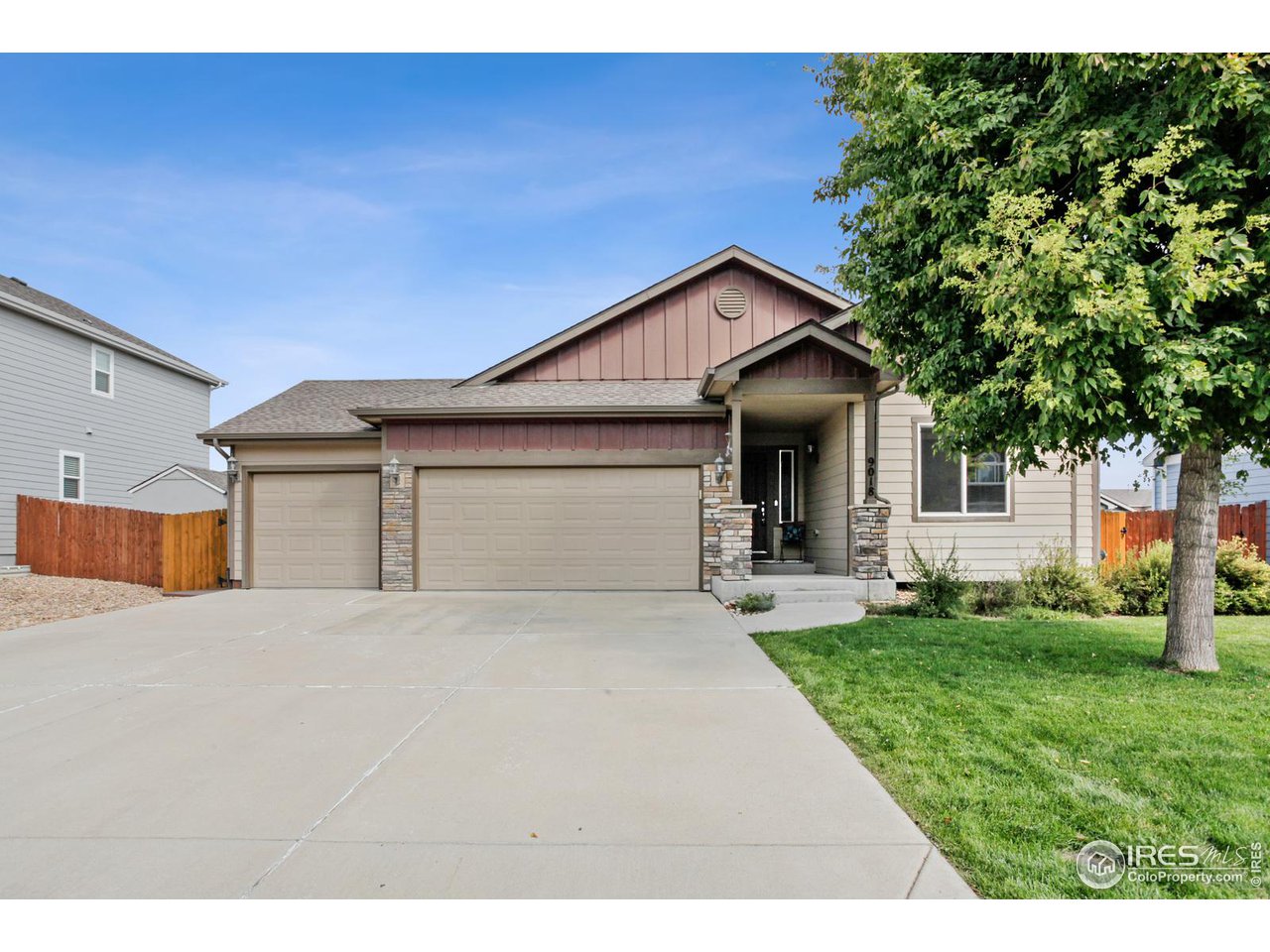 9018 Sandpiper Drive Frederick, CO 80504 - Photo 3 of 26 a front view of a house with a yard and garage