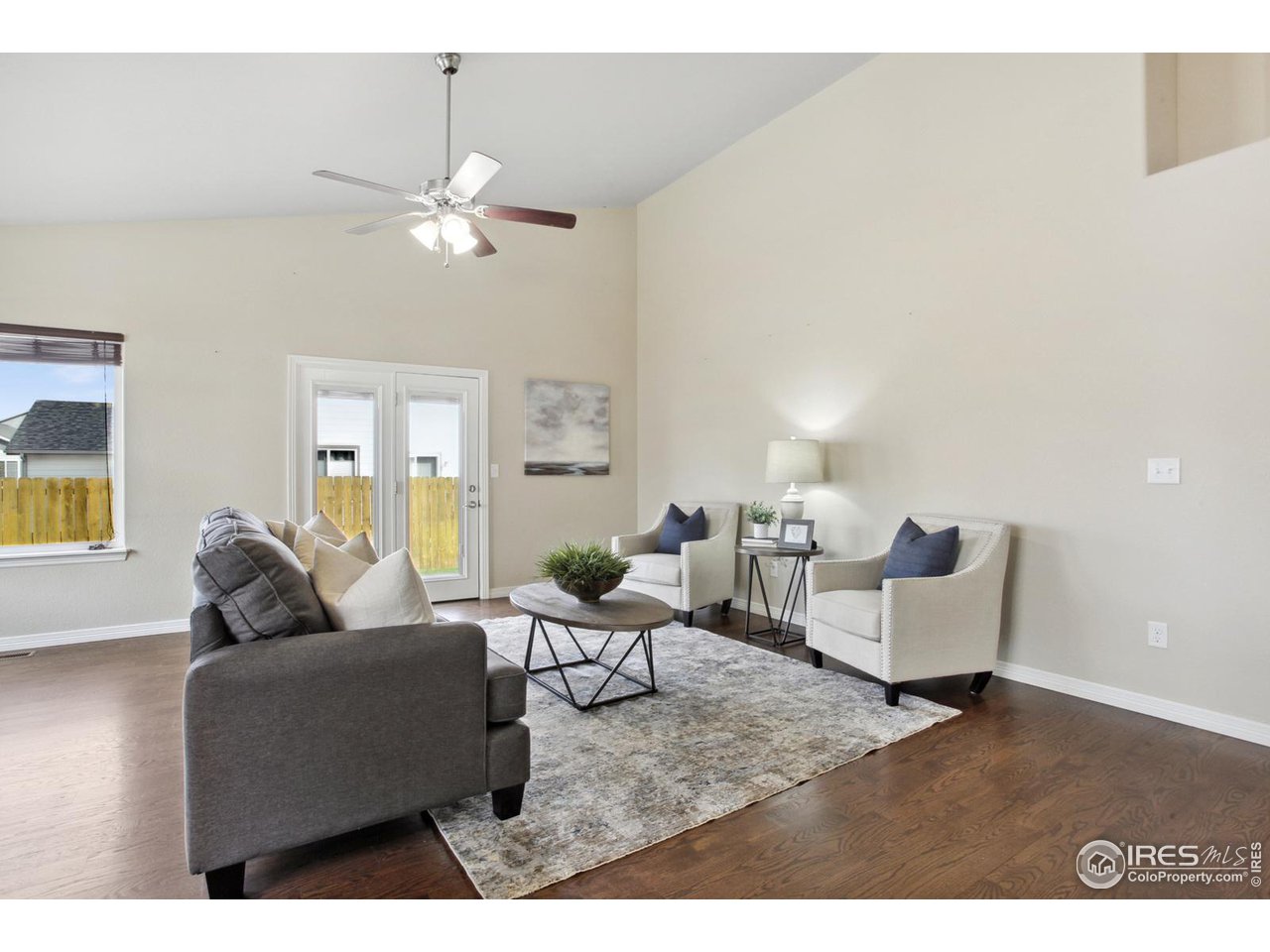 9018 Sandpiper Drive Frederick, CO 80504 - Photo 7 of 26 a living room with furniture and a chandelier