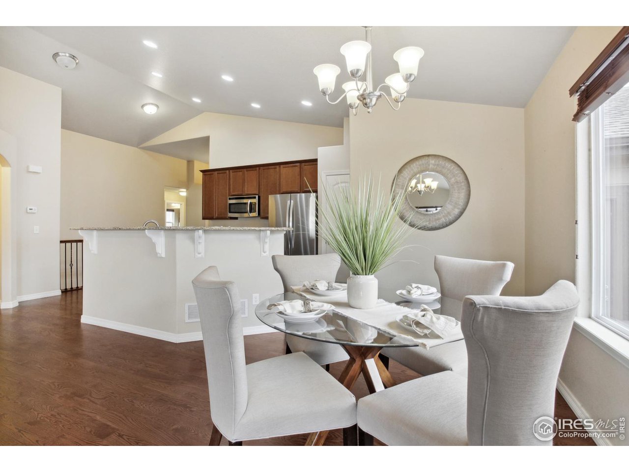9018 Sandpiper Drive Frederick, CO 80504 - Photo 9 of 26 a living room with kitchen island furniture and a chandelier