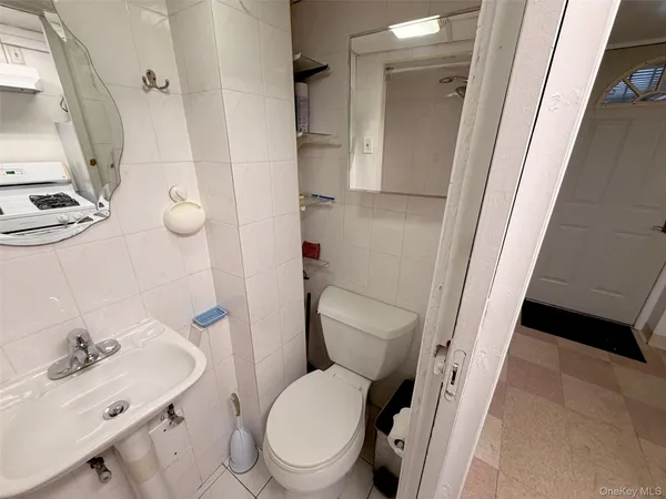 a white toilet sitting next to a bathroom sink