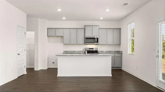 a kitchen with stainless steel appliances a sink stove and refrigerator